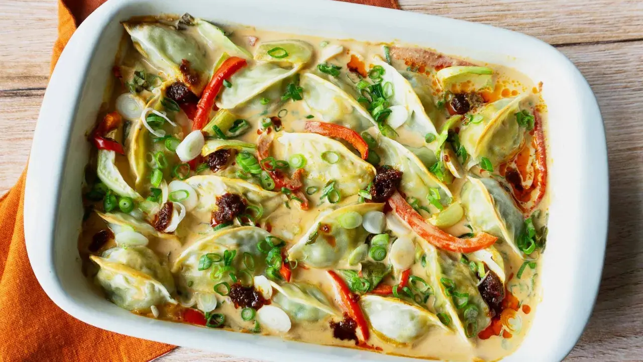 Gyoza in cremiger Sauce mit Paprika und Frühlingszwiebeln, eine köstliche Beilage.