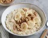 Cremiger Porridge mit Bananenscheiben, Nüssen und Zimt – ein leckeres Porridge Rezept mit Banane für einen guten Start in den Tag.
