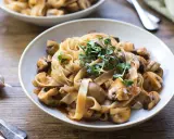 Herzhafte Pasta mit Pilzsauce, ein italienischer Genuss, garniert mit frischen Sprossen.