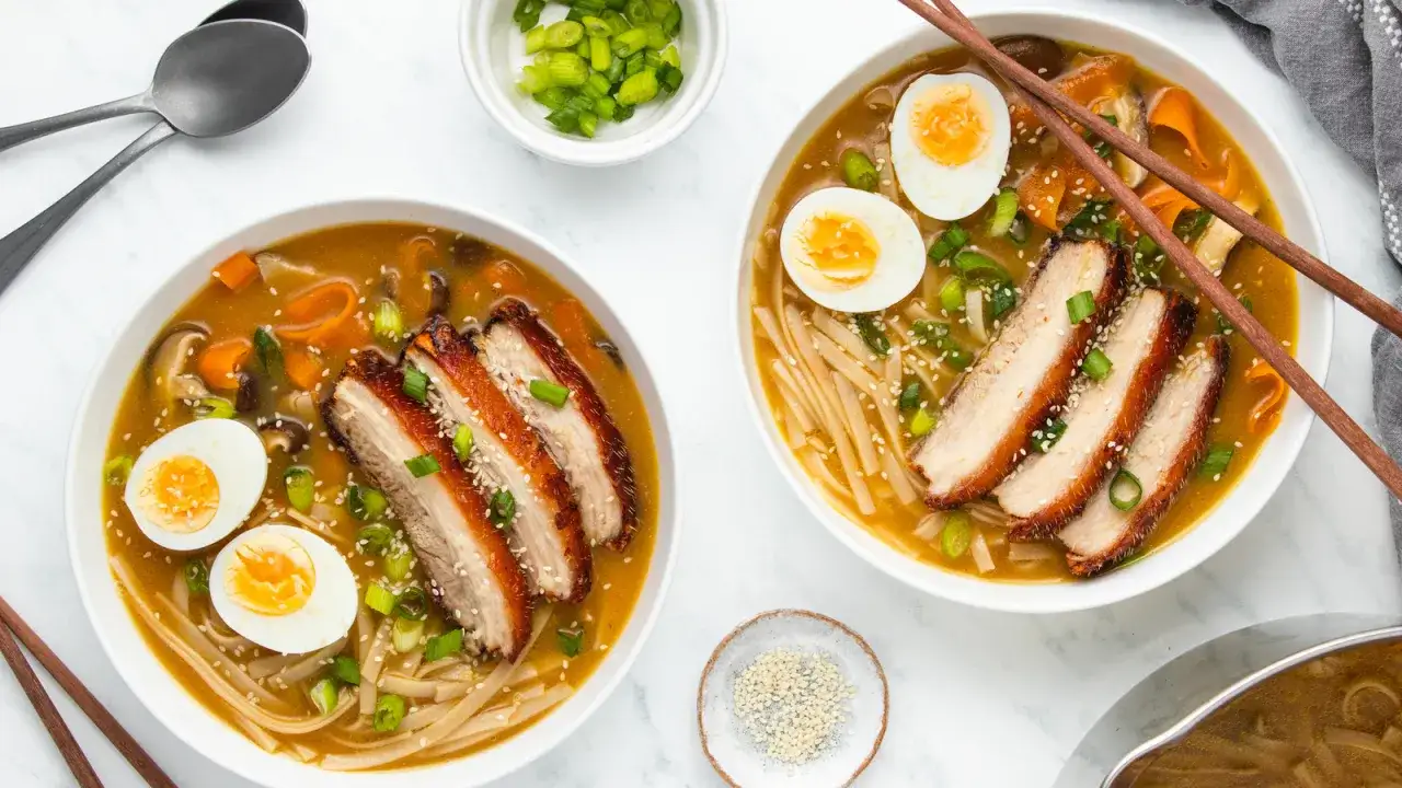 Zwei Schüsseln Ramen mit Chashu-Schweinebauch, gekochtem Ei und Frühlingszwiebeln. Ein köstliches Chashu Rezept, das zum Nachkochen einlädt.